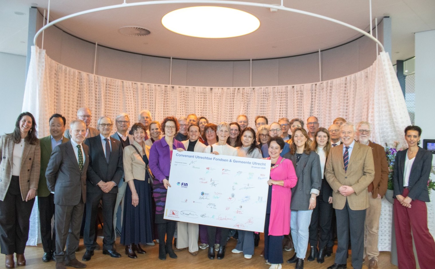 Afgevaardigden van de twintig fondsen en de gemeente poseren met het convenant.