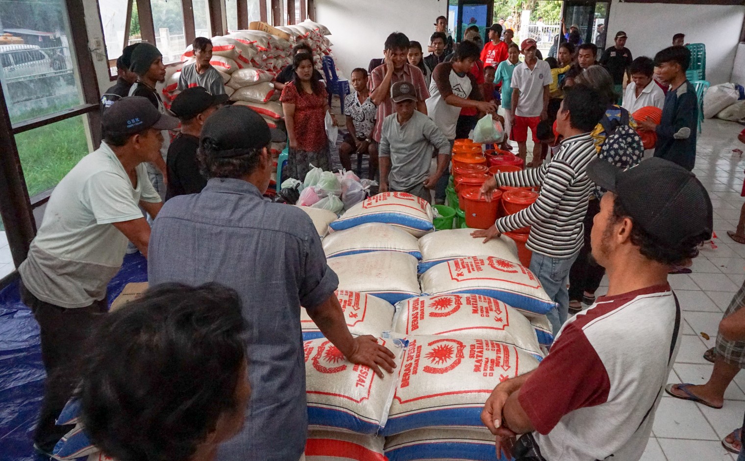 Hulpverleners geven voedsel uit aan overlevenden van de natuurramp.